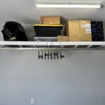 Front view of GearBlocks large swivel hooks hanging under a wall mounted spider rack!