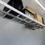 View of GearBlocks large swivel hooks hanging under a wall mounted spider rack.