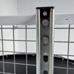 Close up of a strut channel and GearBlocks endcap hanging under a white spider rack.