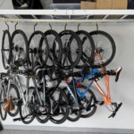 Bikes hanging under a white spider rack using GearBlocks Swivel hooks.